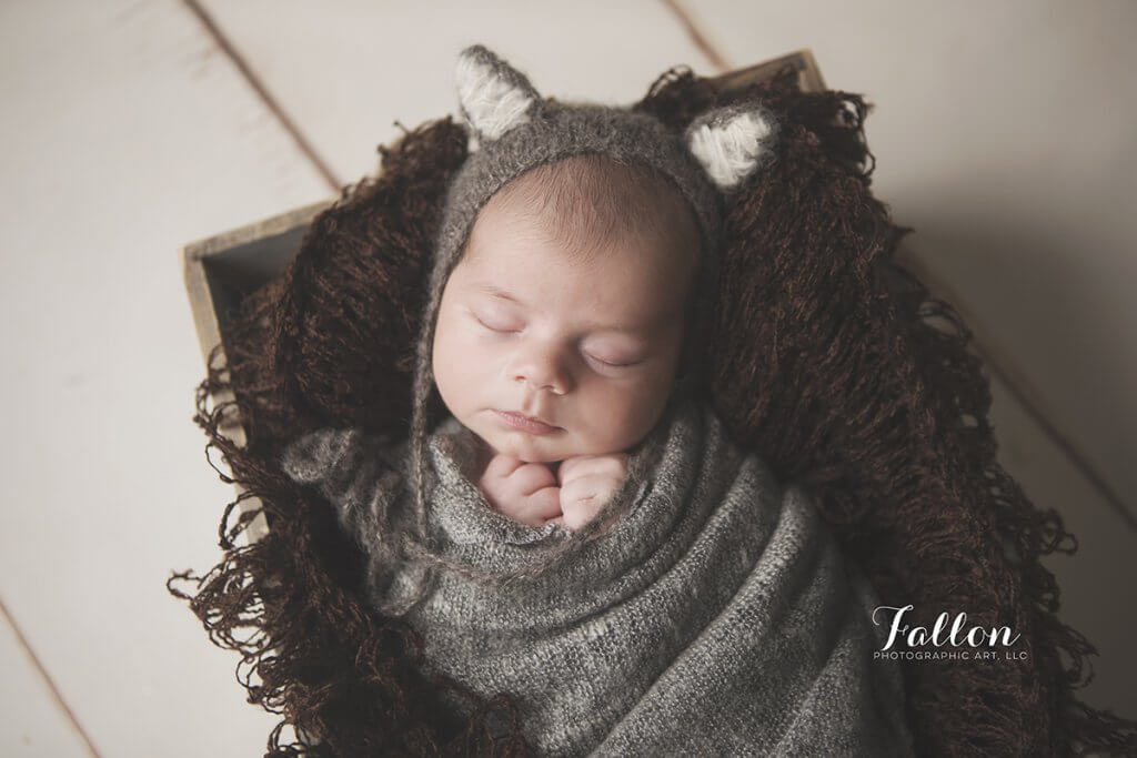 sweet newborn in crate