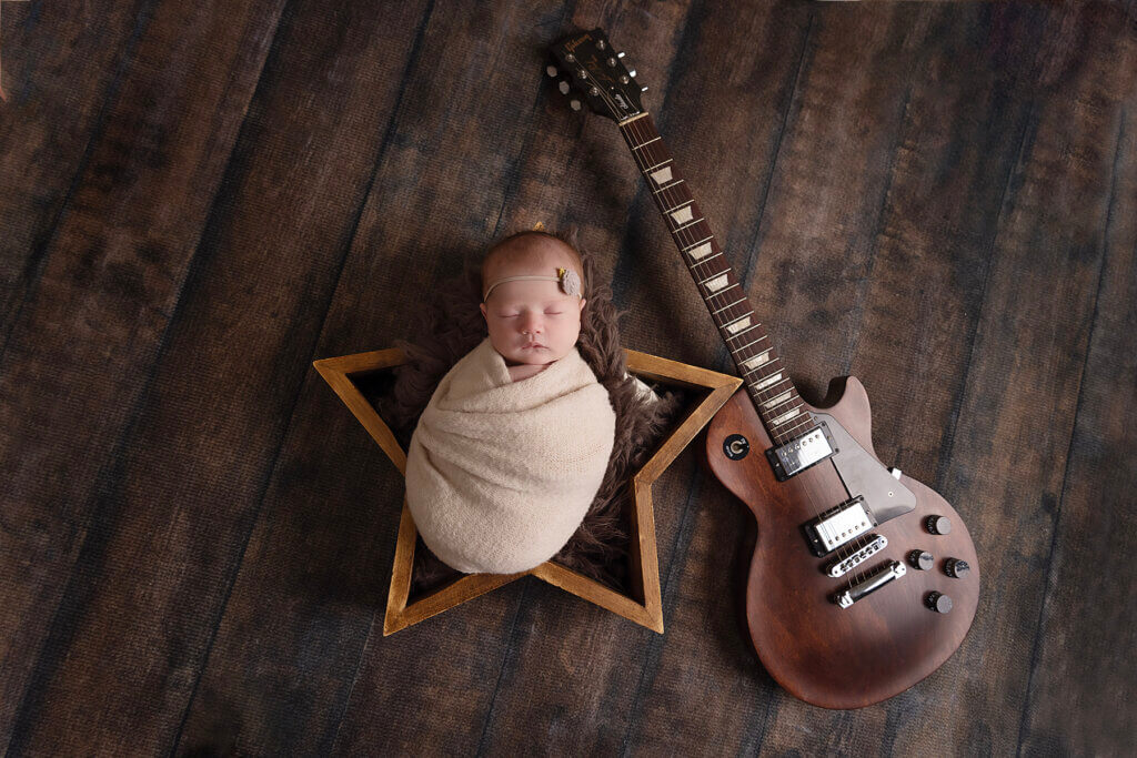 Newborn baby girl with guitar