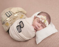sweet newborn baby with dog tags